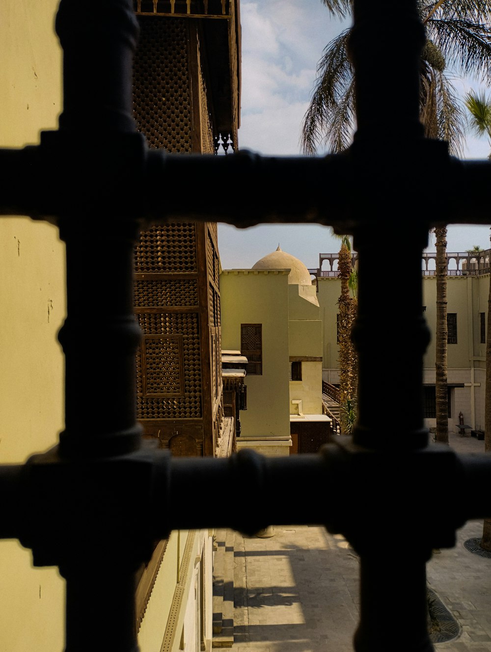 a black pipe with a building in the background