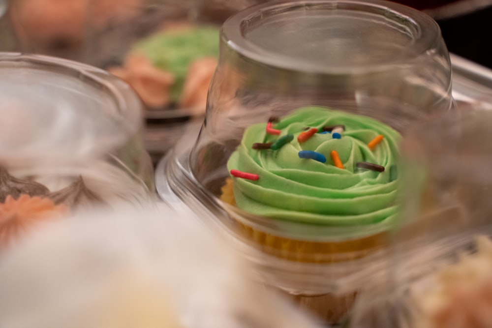 a green and yellow dessert in a clear glass container