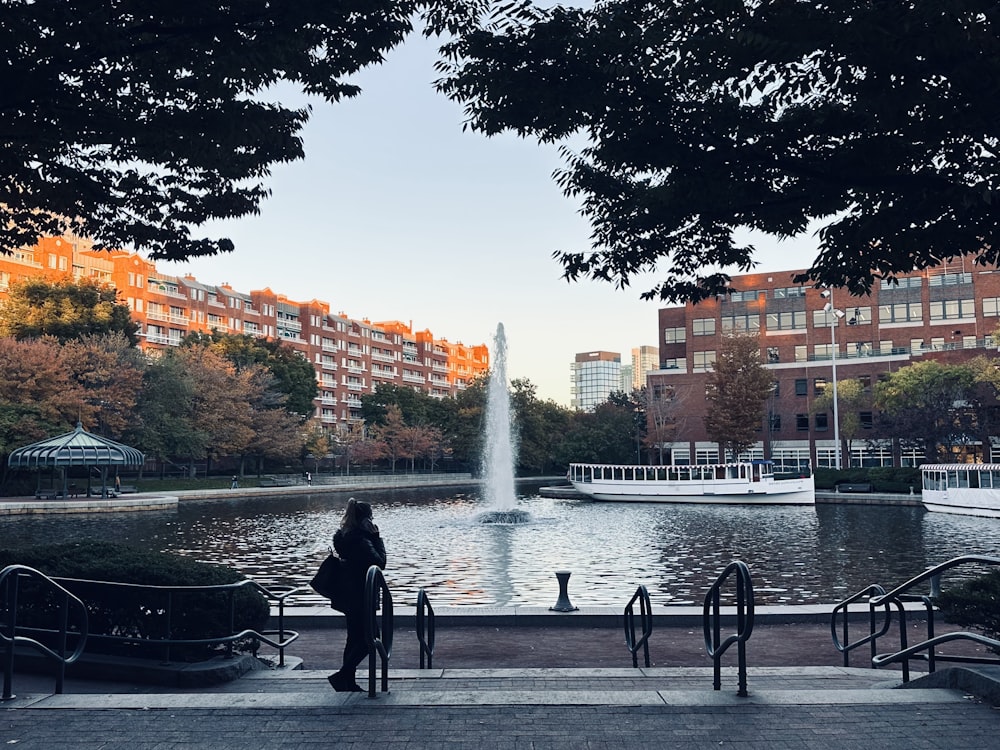 a person standing next to a fountain