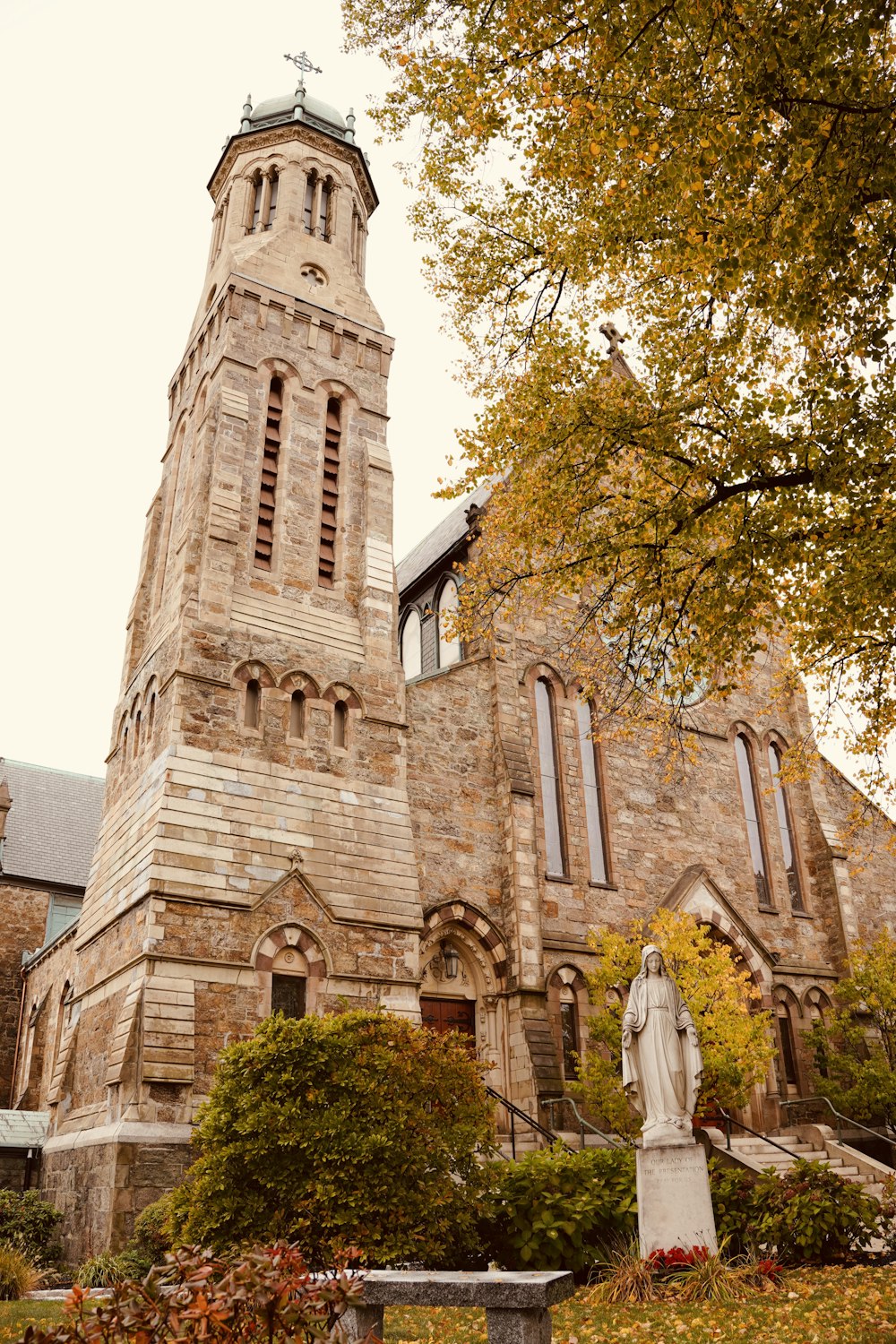 a large stone building with a statue in front of it