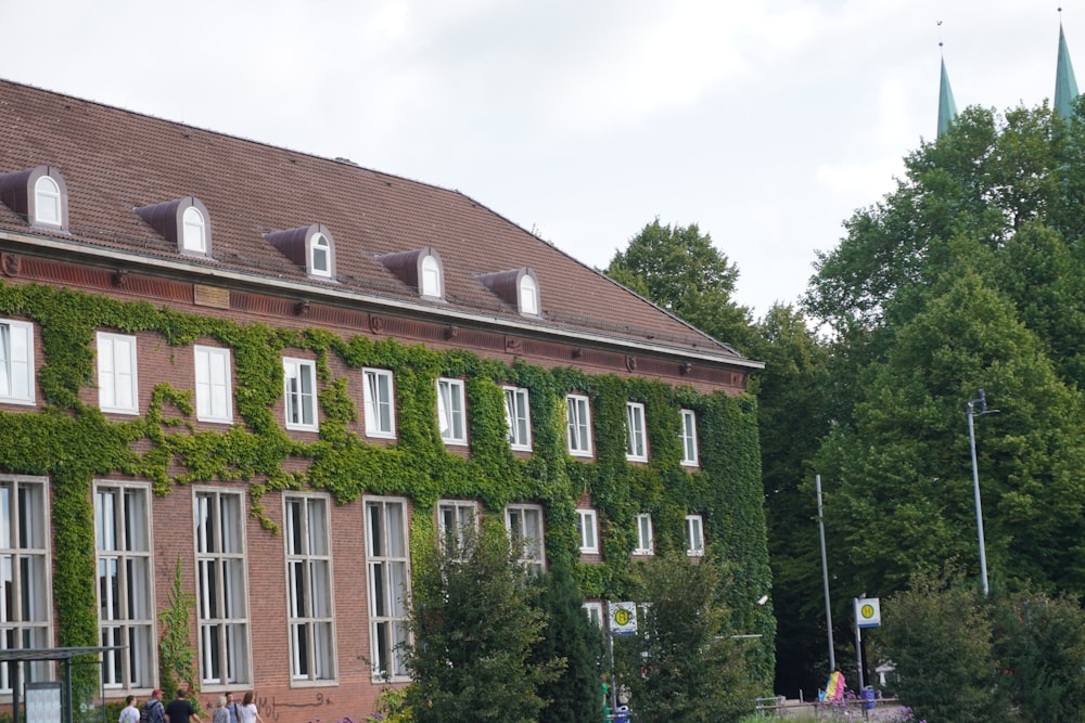 a large brick building with trees in the front