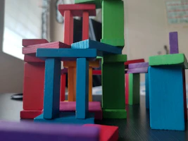 Close-up of colorful building blocks arranged in a playful pattern on a white surface.
