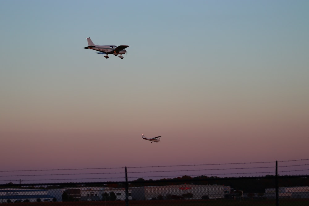 a couple of airplanes flying in the sky