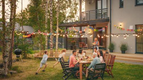 a group of people sitting around a table outside