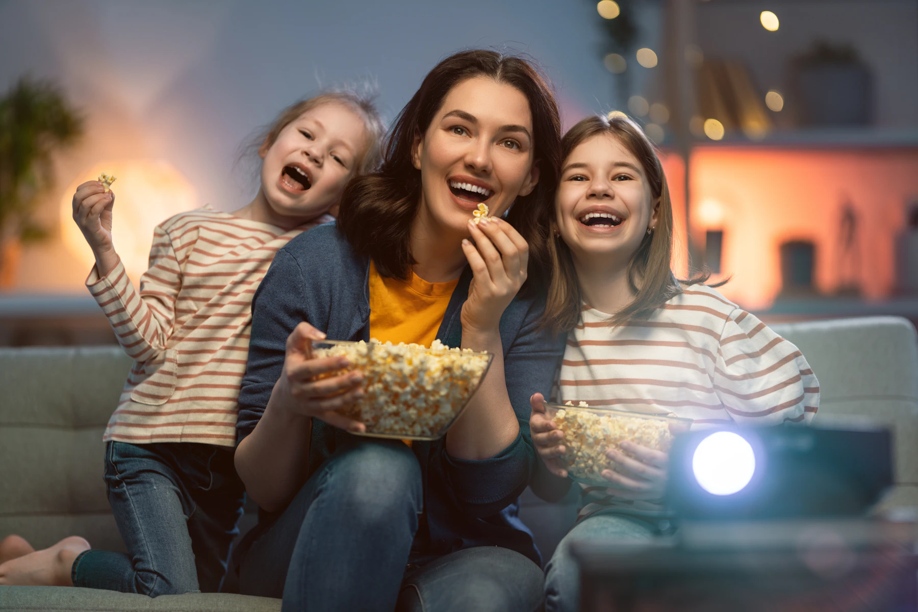 A person watching a movie at home with popcorn