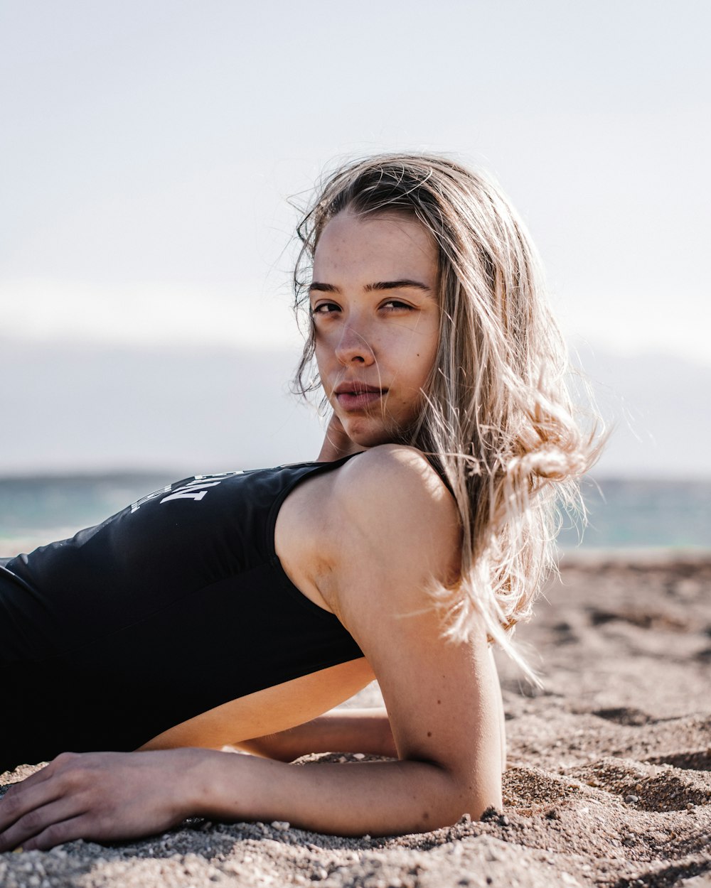 a woman lying on the beach