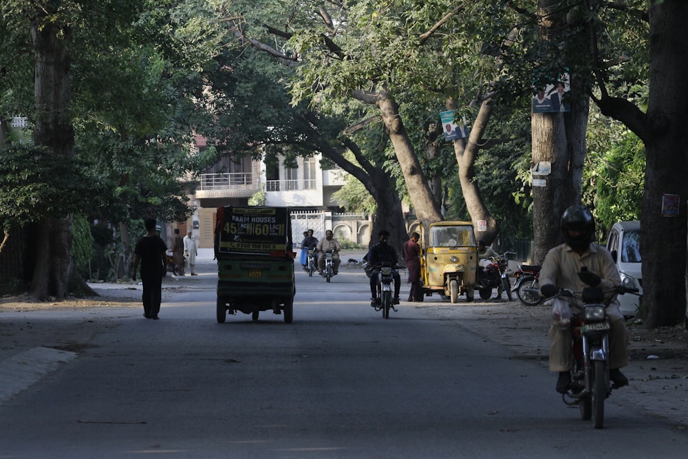 a person riding a motorcycle down the street