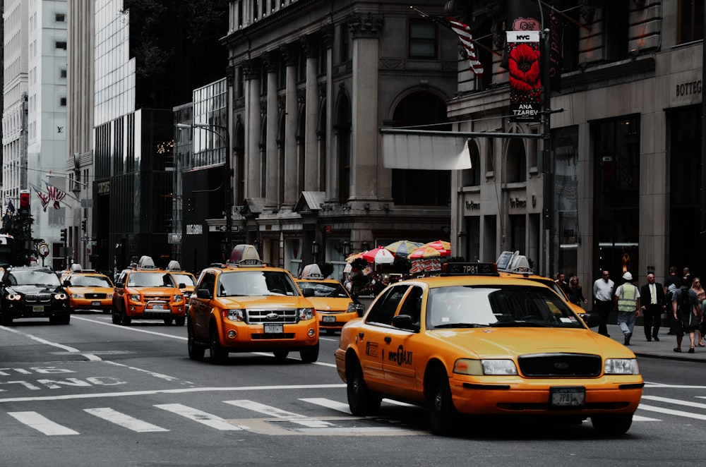 a group of taxi cabs on a city street