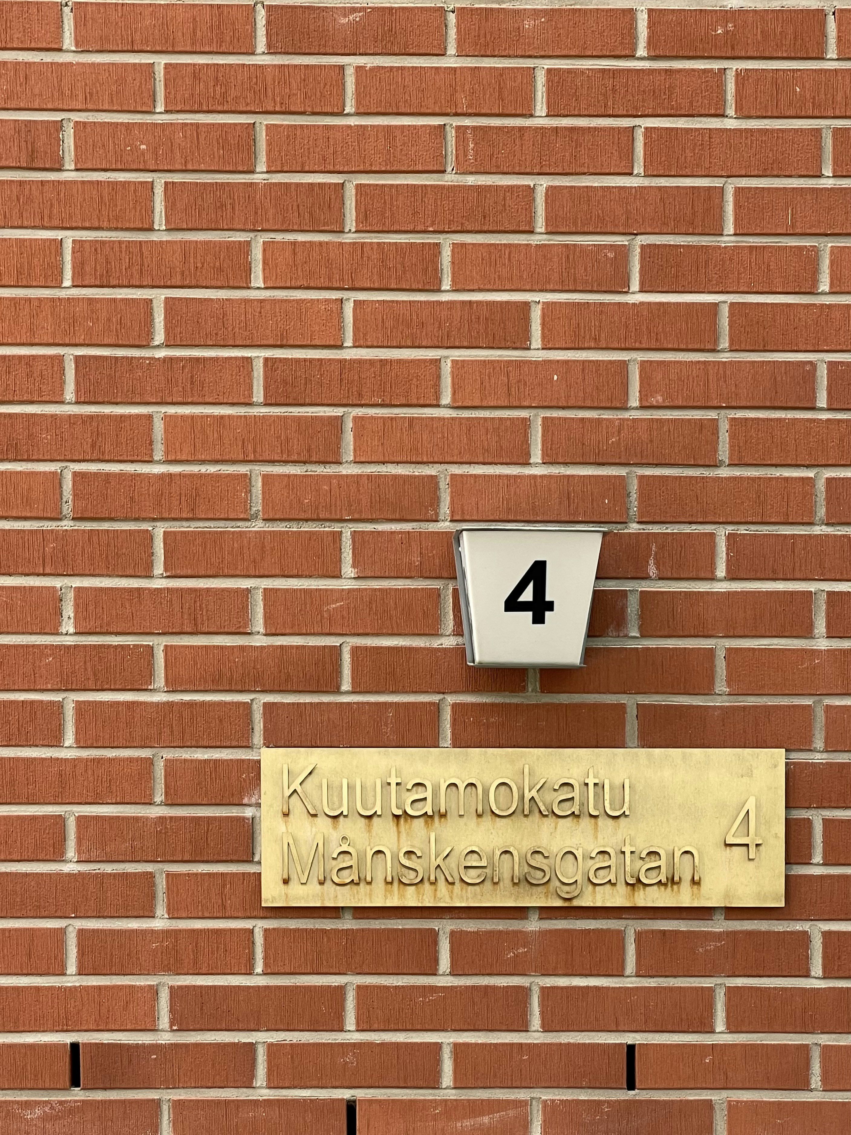 a sign on a brick wall