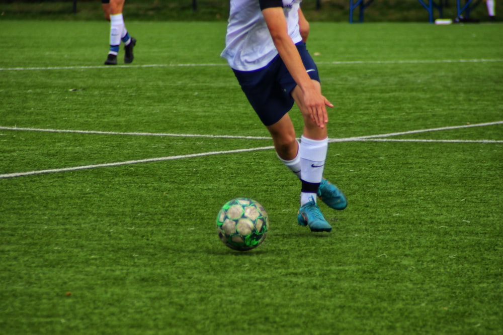 a person kicking a football ball