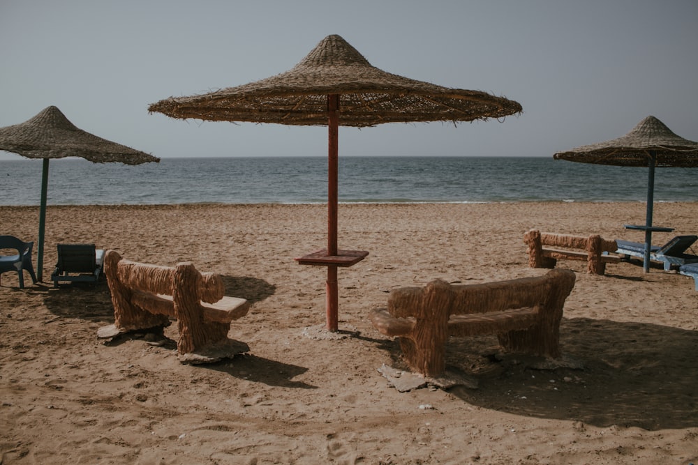 a beach with umbrellas and chairs