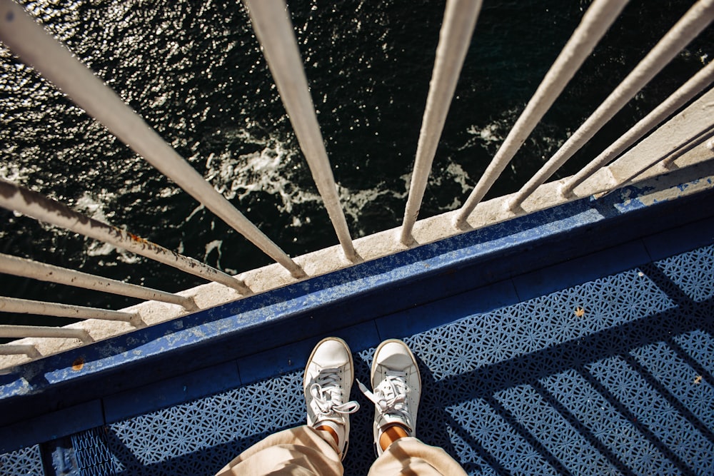 a pair of feet on a metal railing