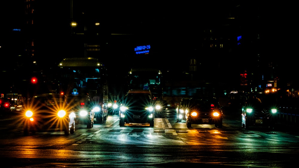 a group of cars on a street at night