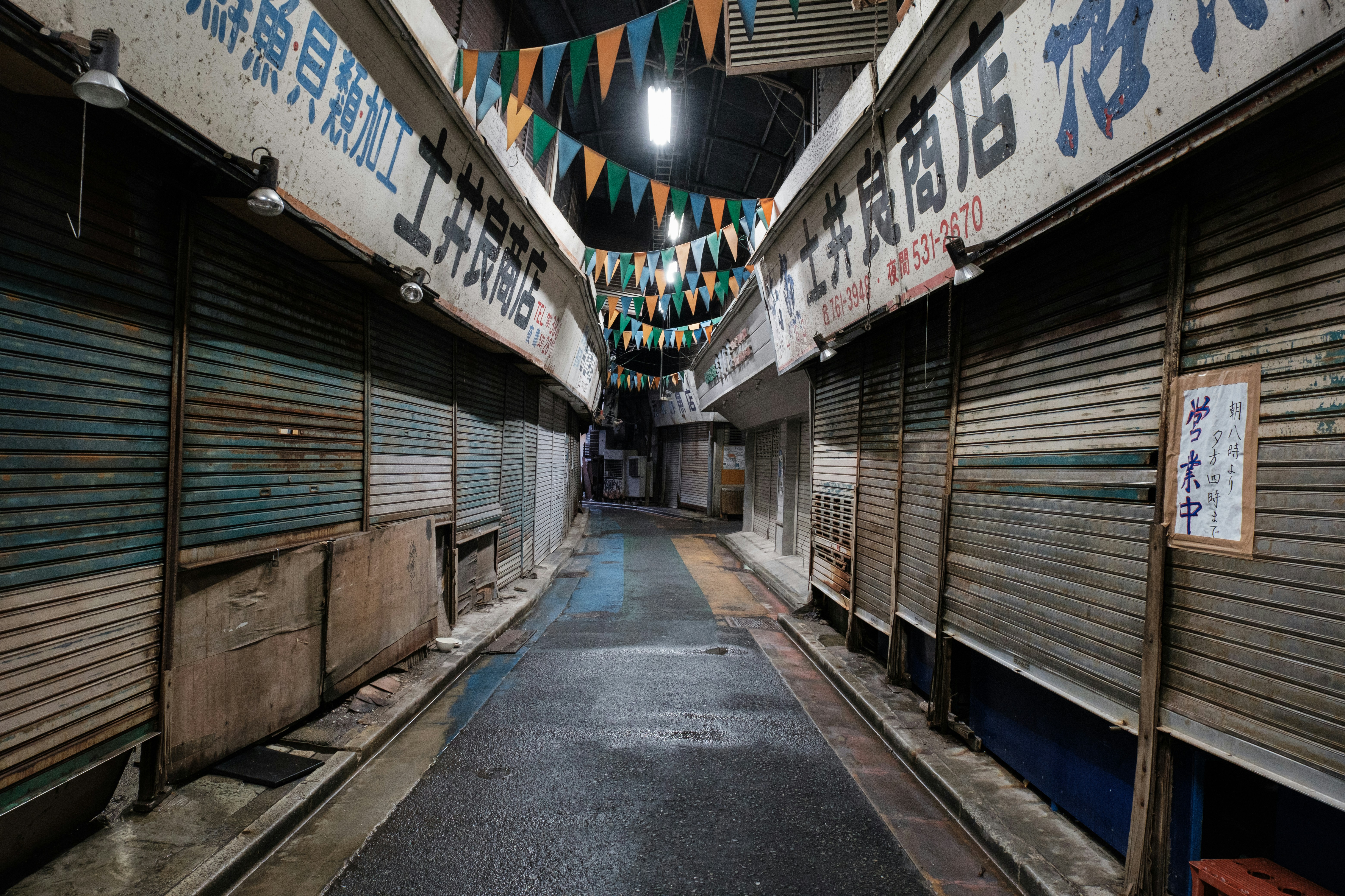 Darkened street in Japan with closed shop fronts during New Year