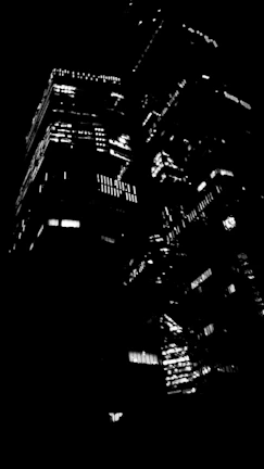 Cinematic cityscape at dusk with sharp contrasts and glowing lights.