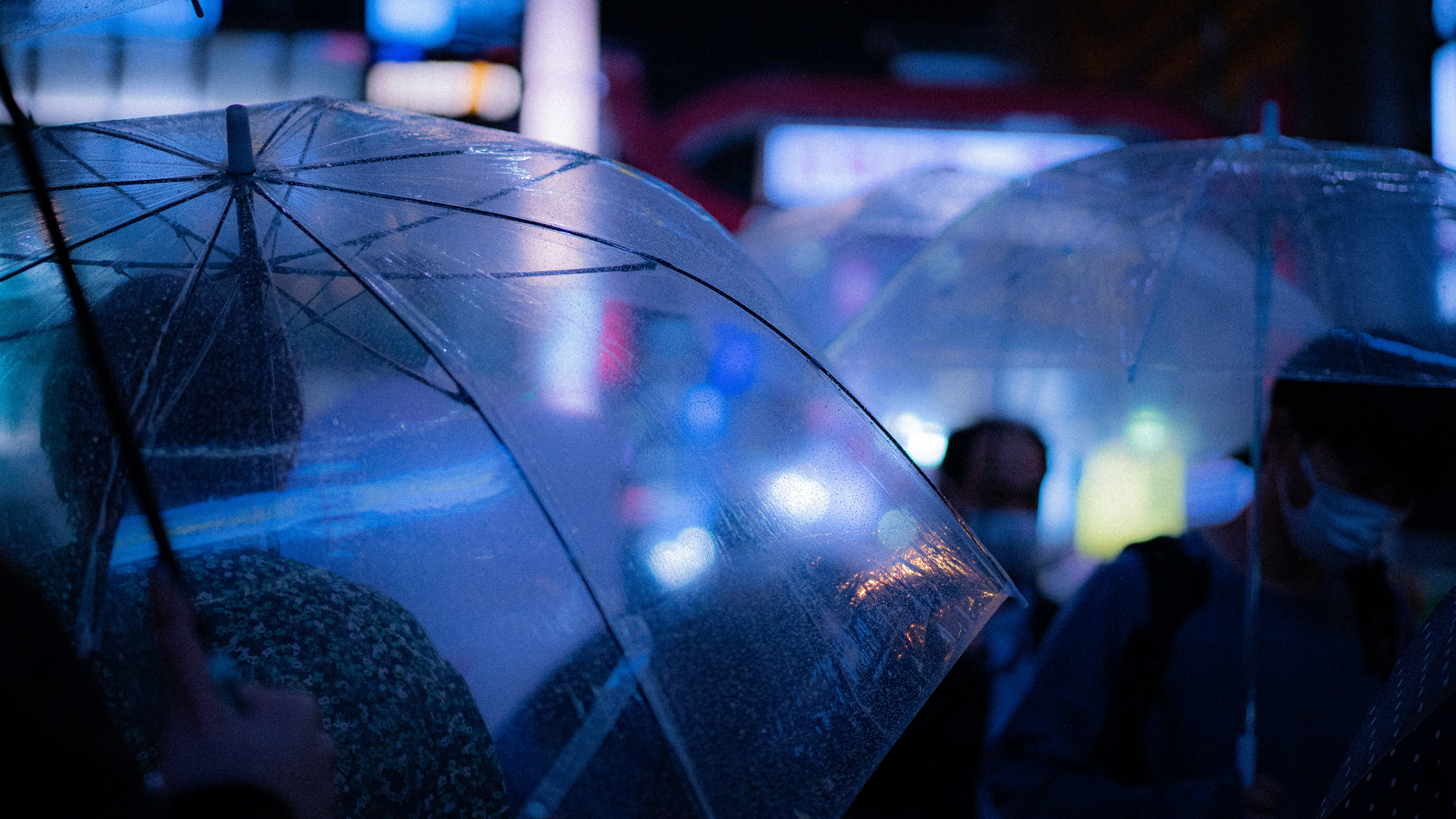 protective umbrella shielding a house, car, and family from storm clouds labeled "Lawsuit" and "Liability" - Personal umbrella insurance reviews