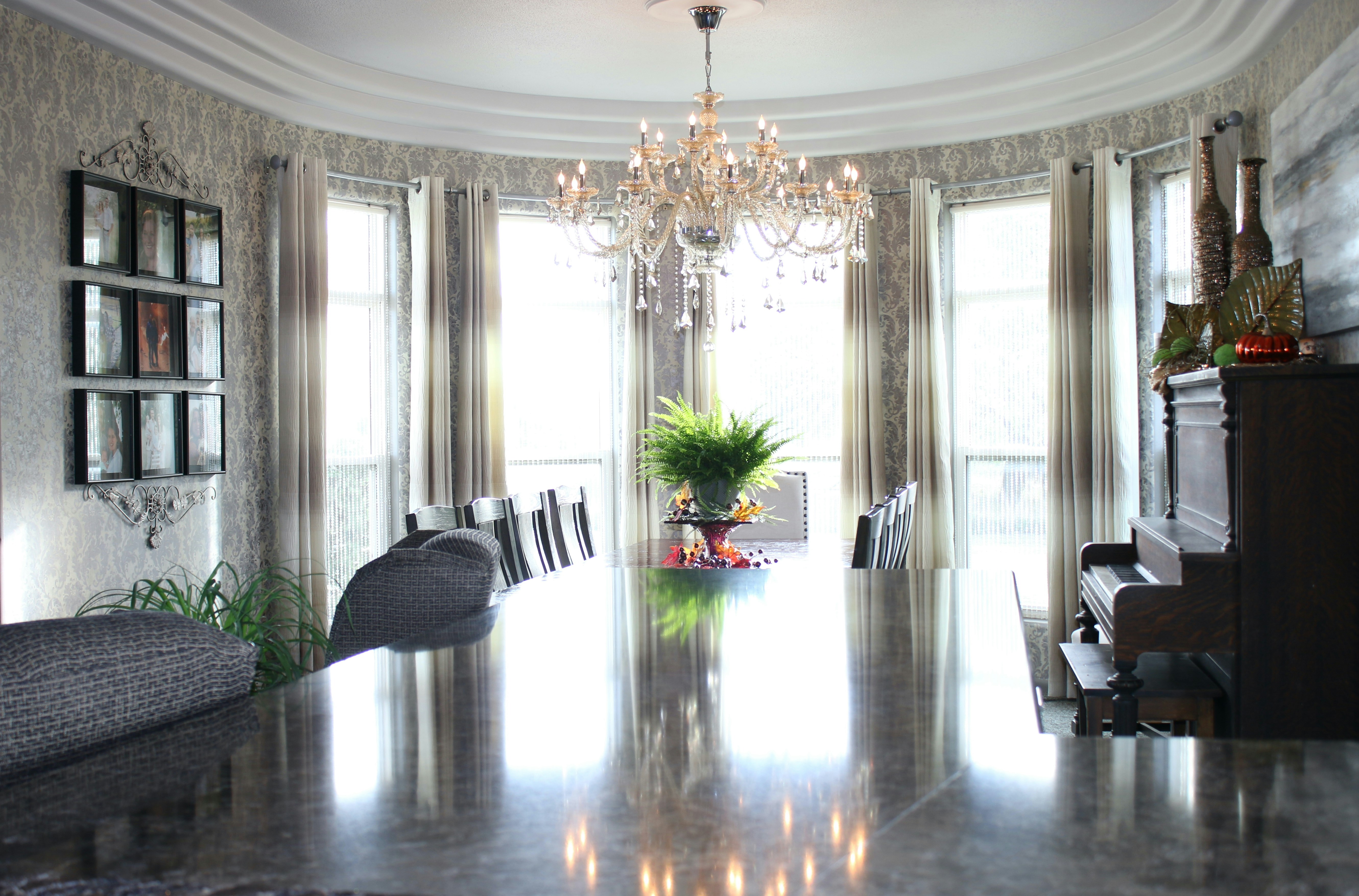 a large room with a piano and chandelier