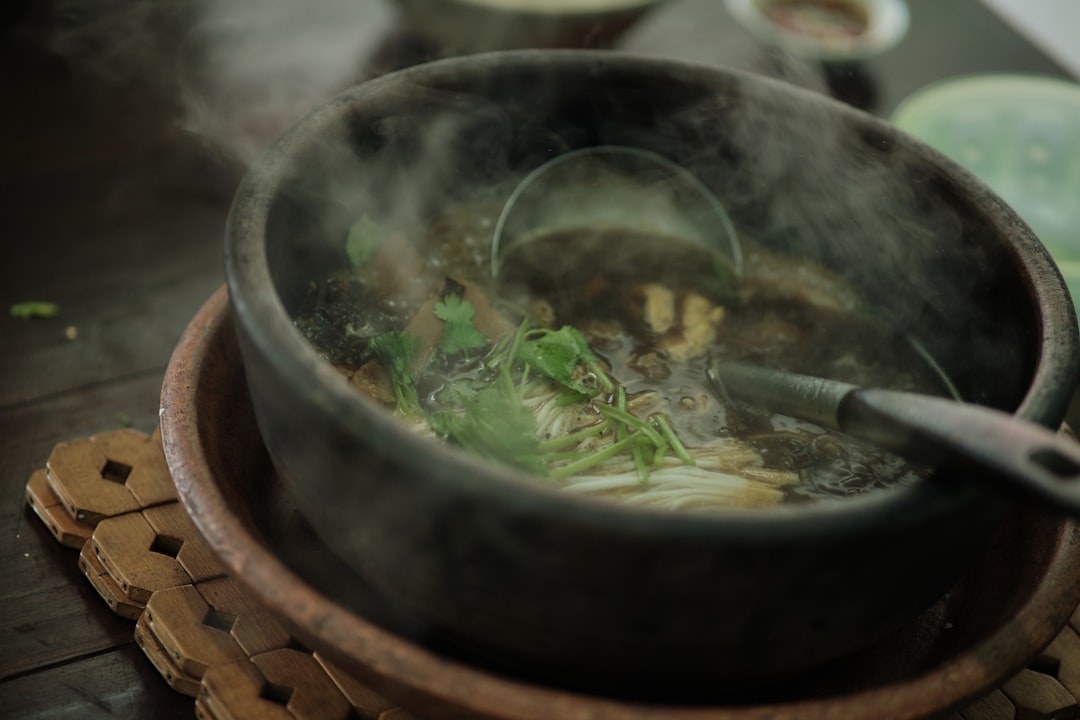 A steaming bowl of Chinese noodle soup, representing Fuzhou's light and broth-based cuisine style
