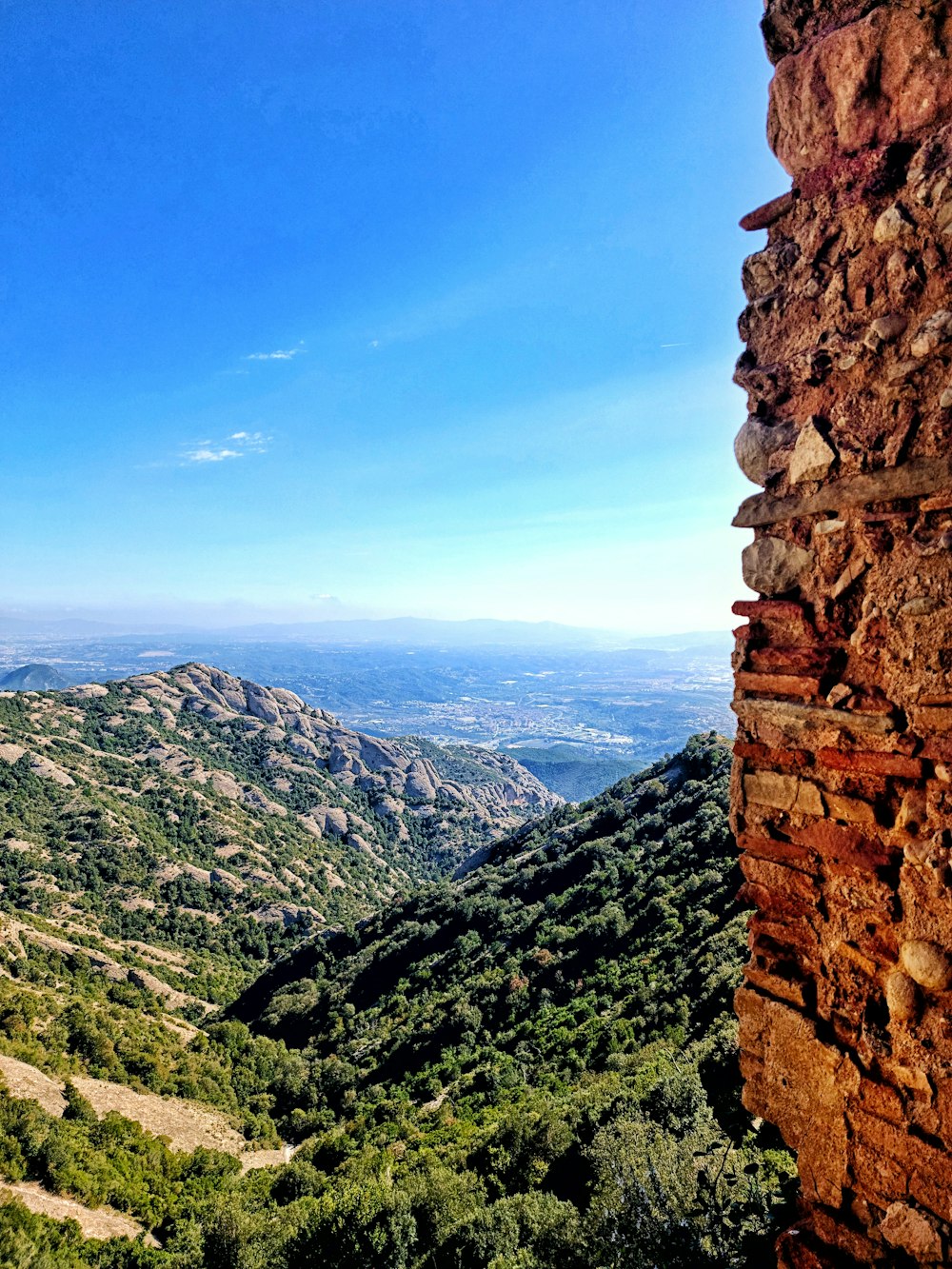 a view of a mountain range from a cliff