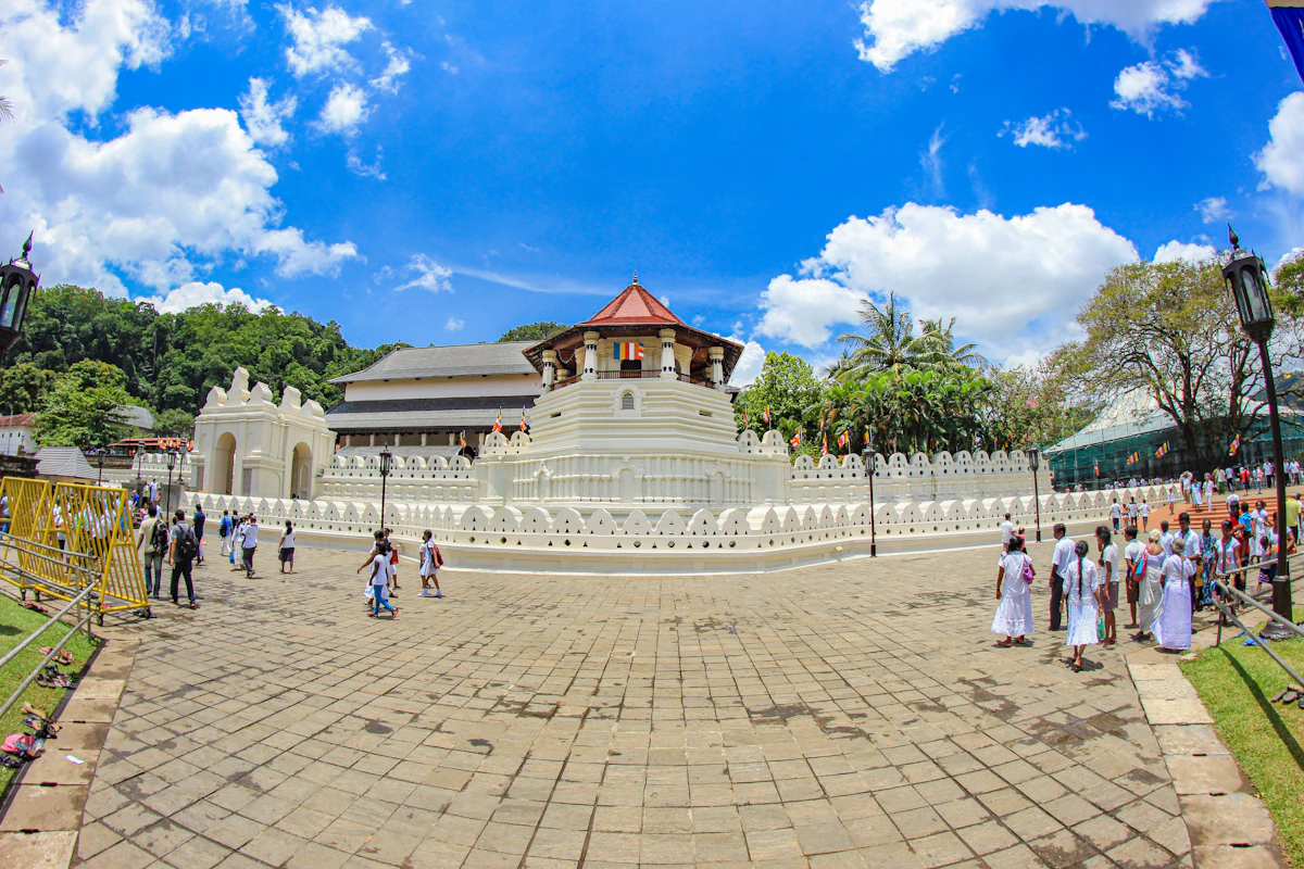 Pilgrims and visitors moving through the Temple of the Tooth precinct in Kandy