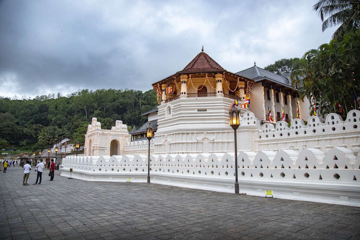 The Temple of the Sacred Tooth Relic in Kandy, Sri Lanka, reflected in the lake at dusk