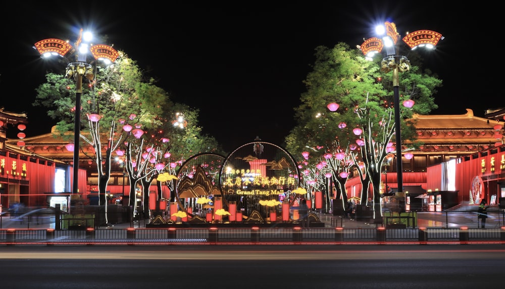 a ferris wheel with lights and trees