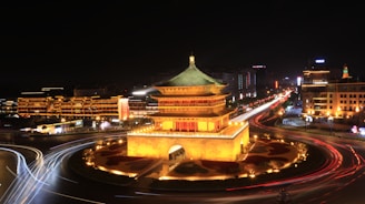 a city with a large building and a fountain in the middle