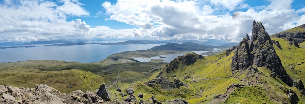 a landscape with hills and a body of water in the background