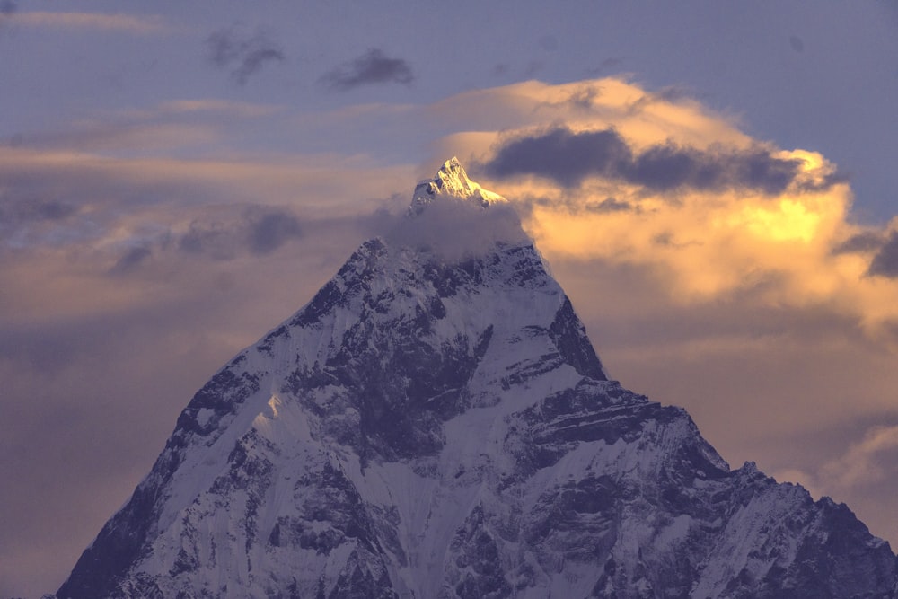 a mountain with clouds above it