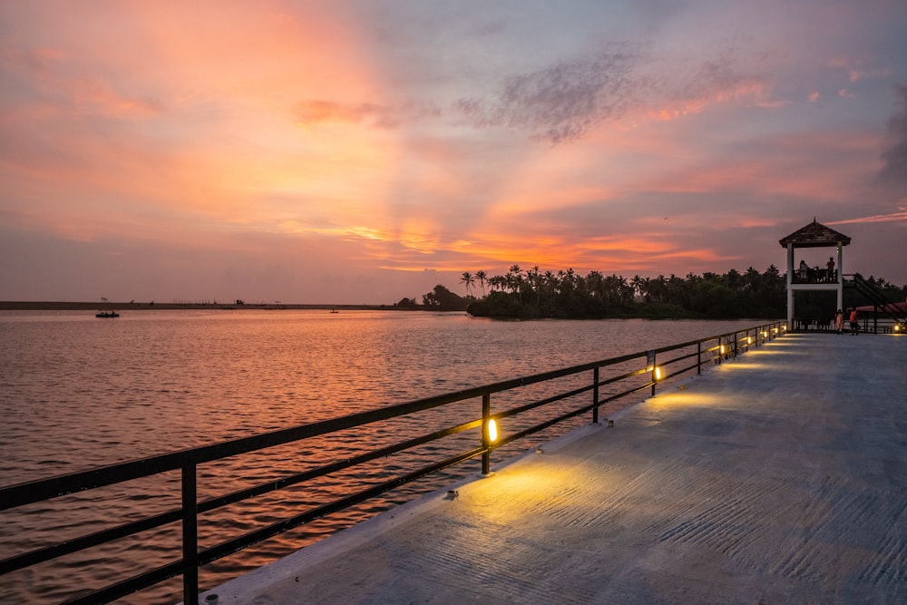 a dock with a building on it by the water