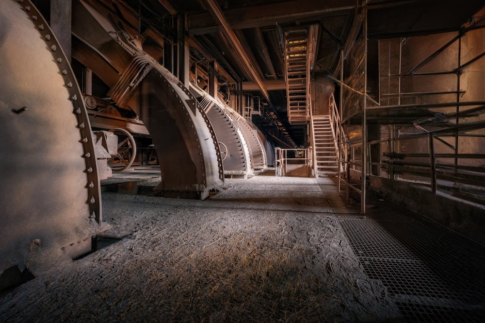 a large room with pipes and a staircase