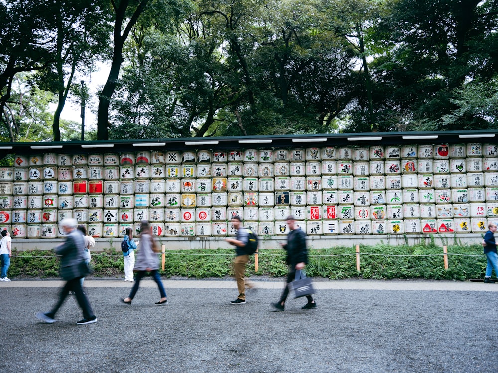 a group of people running in front of a building with signs on it