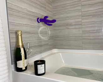 A serene bathroom scene with a misty shower and bottles labeled vinegar and peroxide on the shelf.