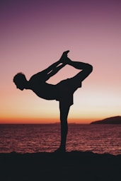 a person doing a handstand on a beach