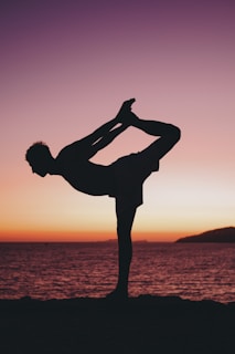 a person doing a handstand on a beach