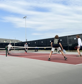 a group of people play tennis