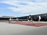 a group of people play tennis