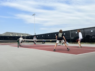 a group of people play tennis