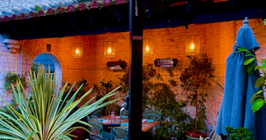A cozy patio illuminated by a warm glowing post lantern from Lumiara.