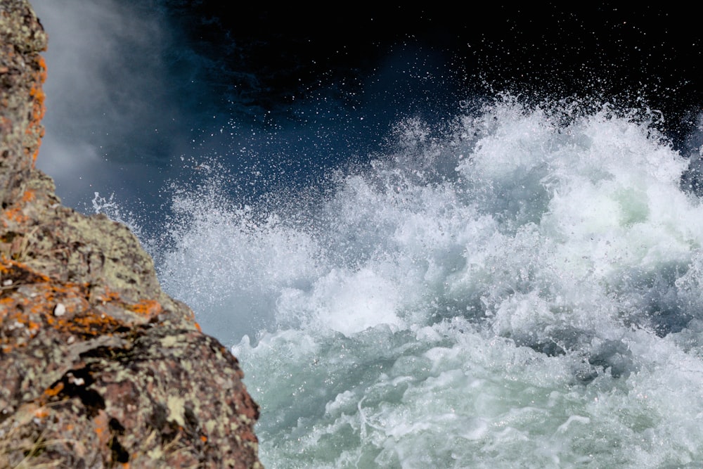 a body of water with rocks and a rocky shore