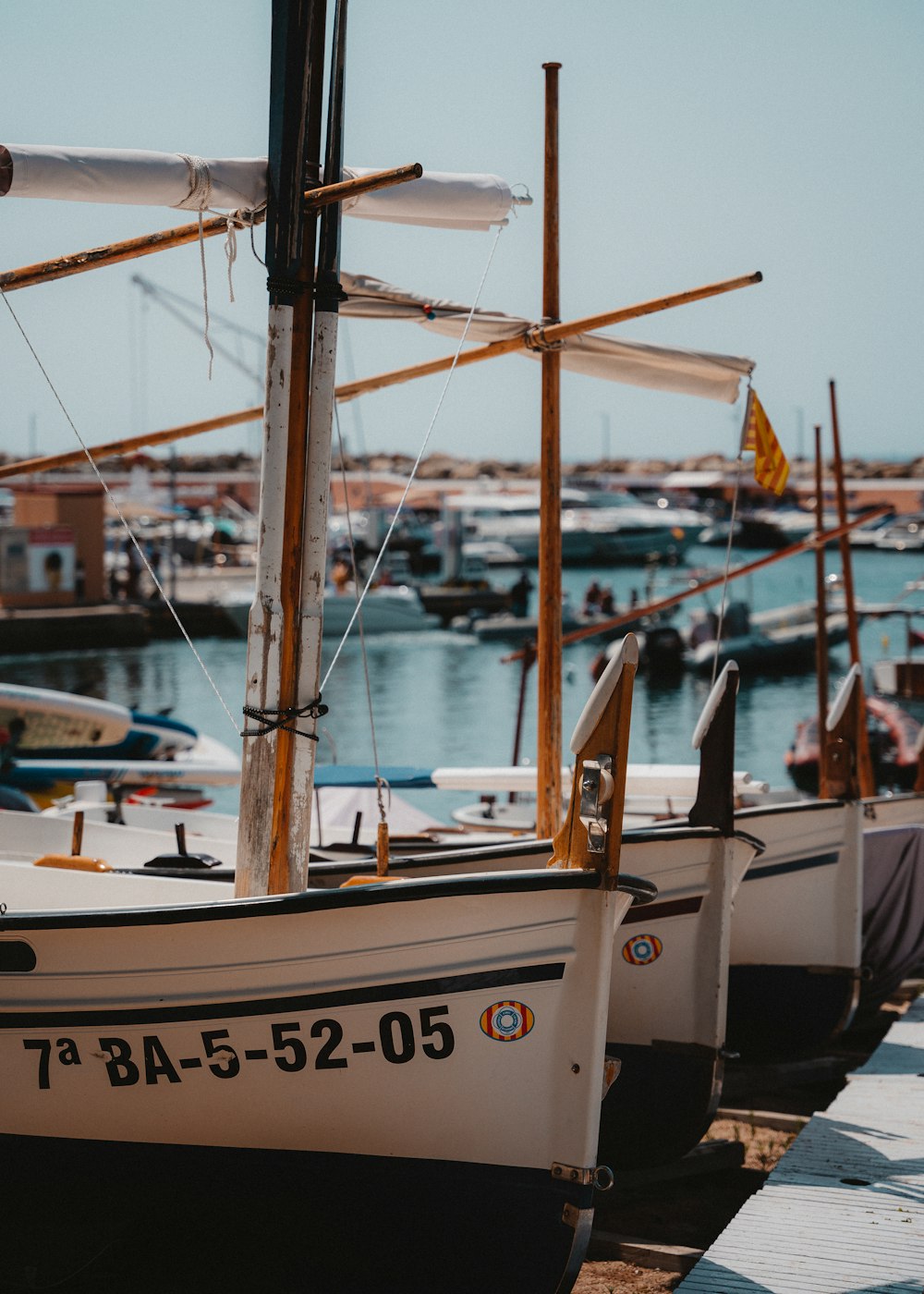 a group of boats sit in a harbor