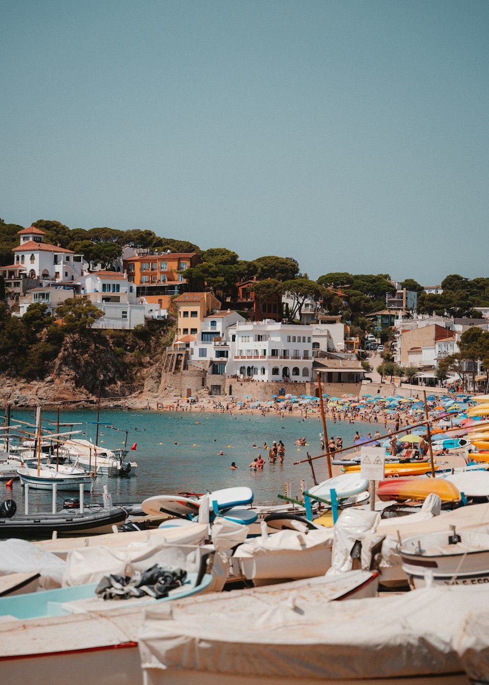a beach with boats and people