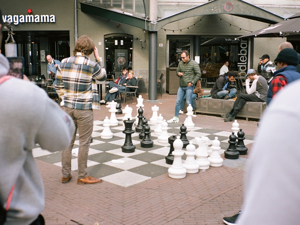 a person playing chess in a public place