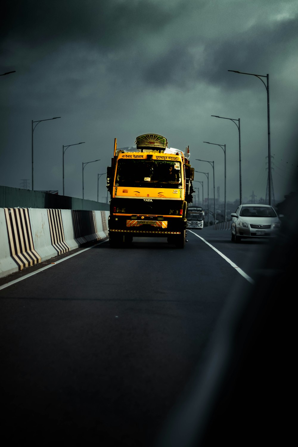 a yellow truck on a road