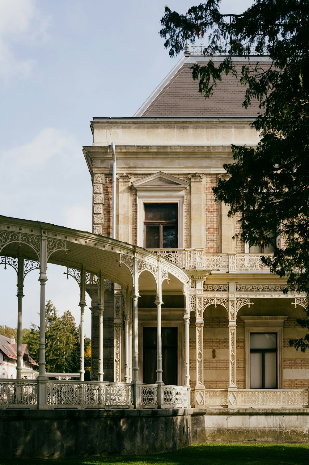 a building with pillars and a fence