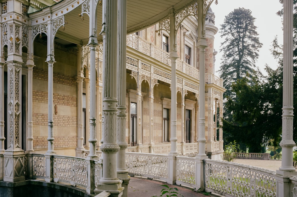 a building with pillars and a fence