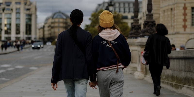 a man and woman walking on a street