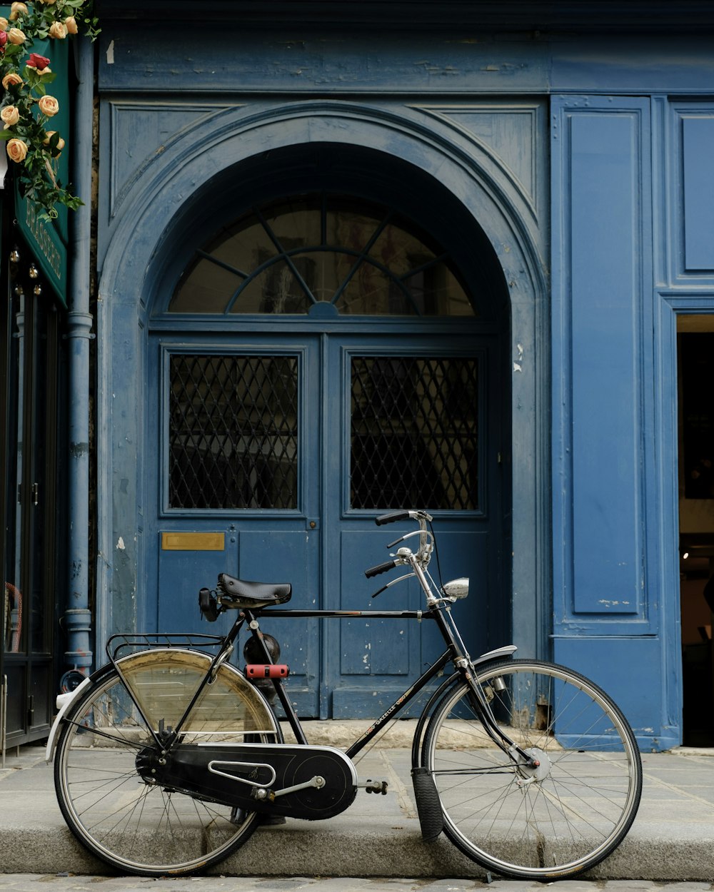 a bicycle is parked in front of a blue door