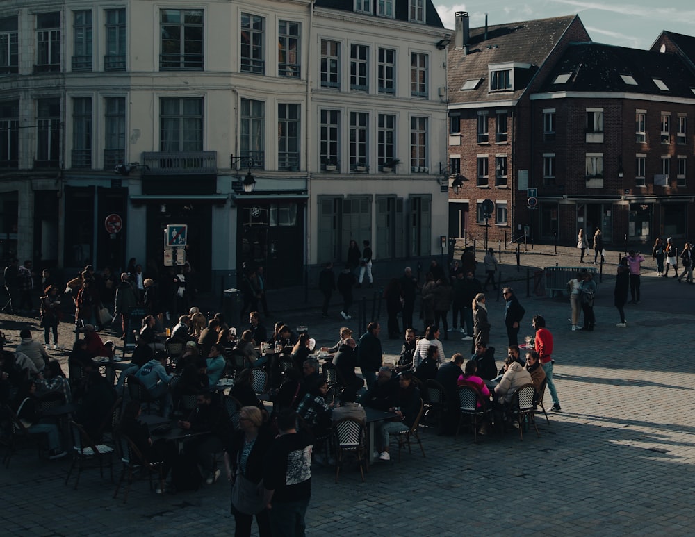 a group of people sitting in chairs outside of a building