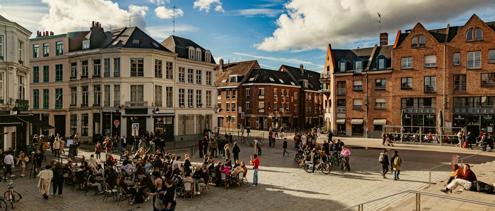 a group of people walking around a town square